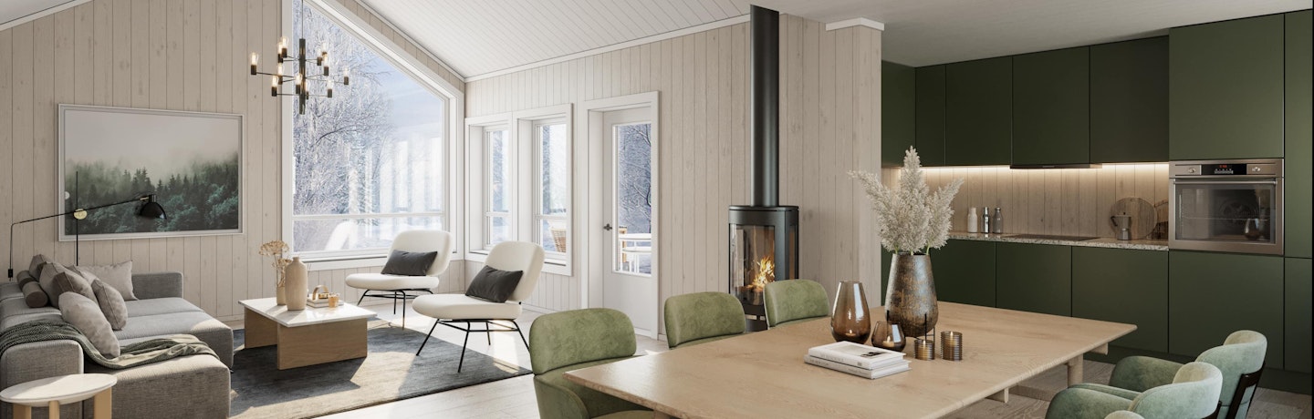 Lys og luftig hytte med åpen kjøkken- og stueløsning i hytta Bruse. Her vist med grønt kjøkken. Store skrå vinduer som slipper vinterlyset inn i stuen.