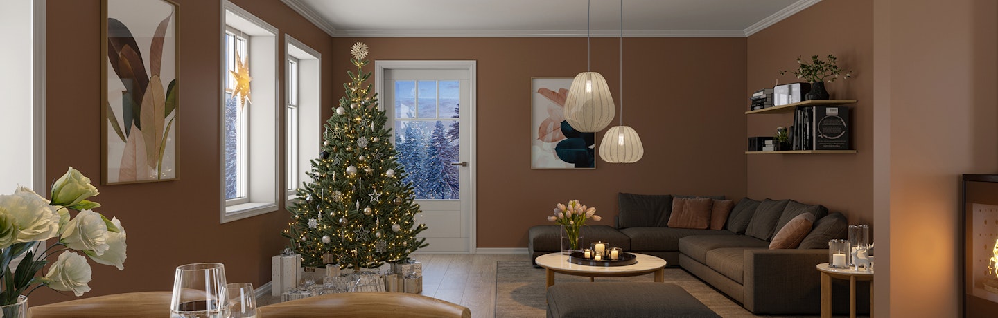 Julestemning i brunmalt stue med juletreet som skinner, julestjernen lyser i vinduet og fyr i peisen. Julestemning i den klassiske husmodellen Desemberfryd.