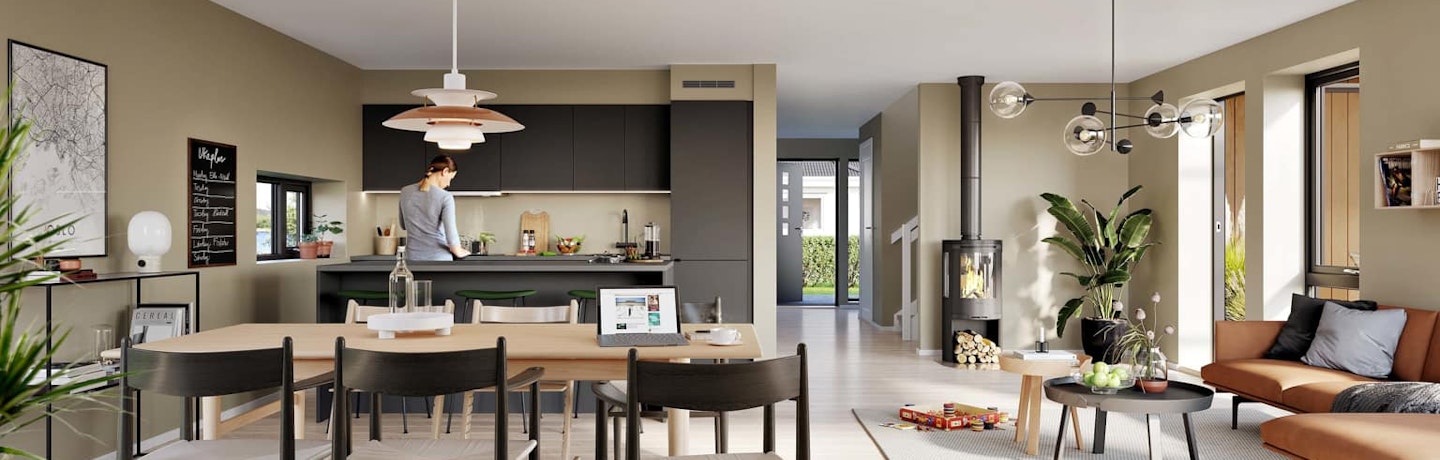 Åpen stue- og kjøkkenløsing i 1. etasje i husmodell Garda. Moderne sort kjøkken med plass til stort spisebord rett ved.