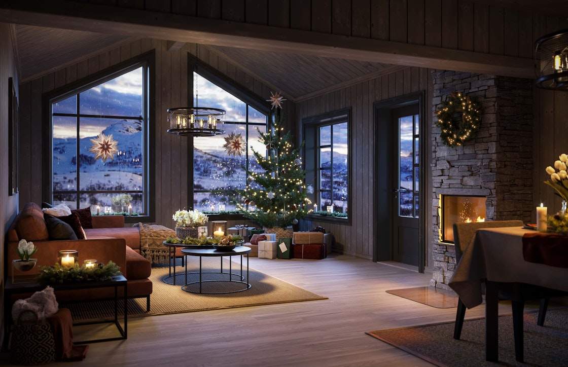 Hytta Bukkespranget er pyntet til julefeiring med juletre, adventstjerner i vinduene og juledekket spisebord.