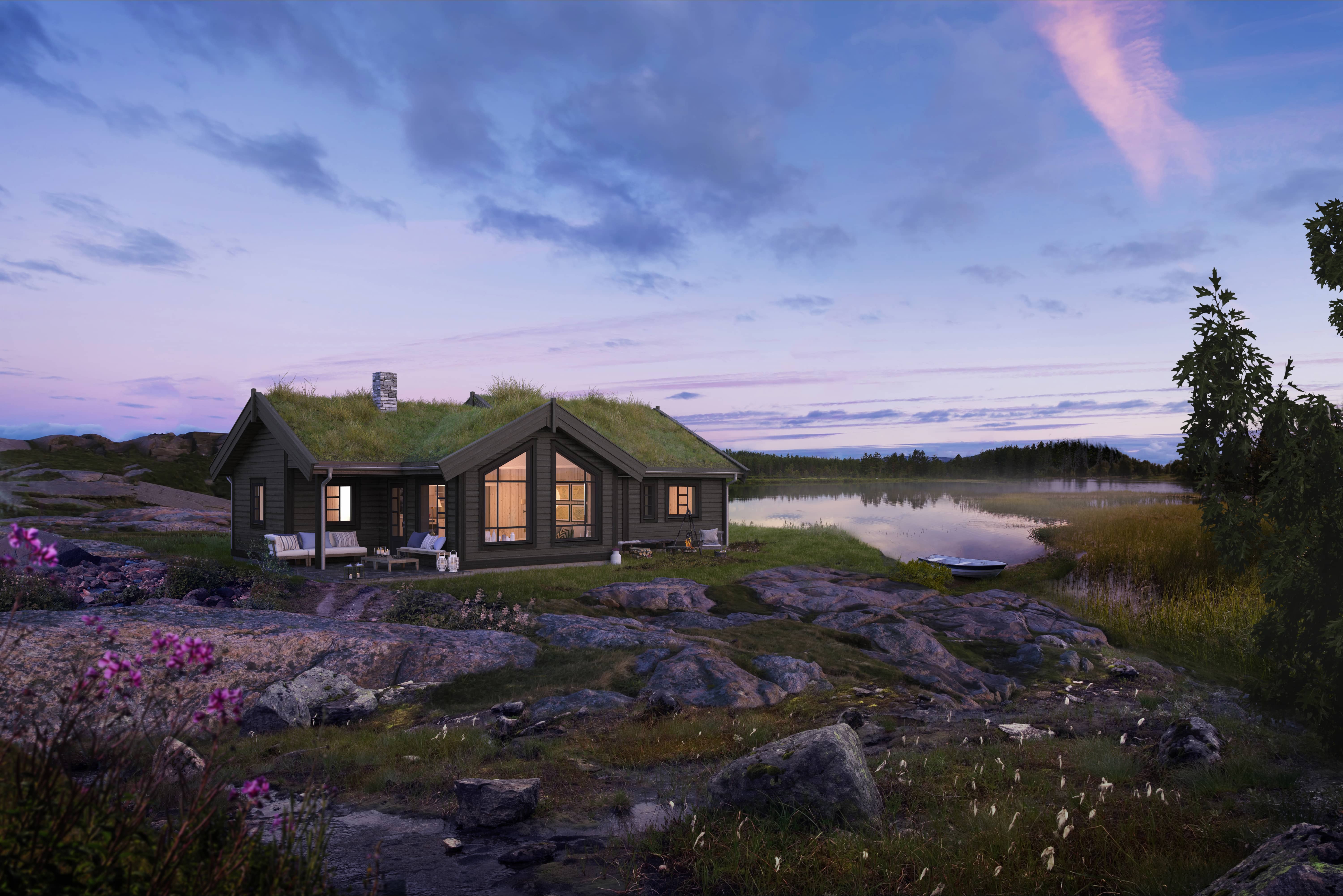 En romslig ferdighytte som her vises i et flott landskap, plassert nede ved vannet. Hyttemodellen heter Bukkespranget.