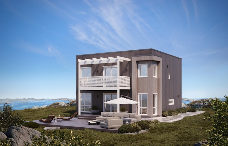 Moderne hus i åpent kystlandskap ved havet. Huset Mynd i to grånyanser med hvite detaljer. Blå himmel kan nytes fra stor uteplass.