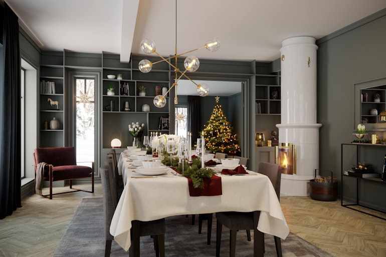 Julepyntet spisebord i en herskapelig spisestue malt i mørk grått med en hvit kakkelovn og stort juletreet som skinner i bakgrunnen. Julestemning i herskapelige husmodell Constantine.